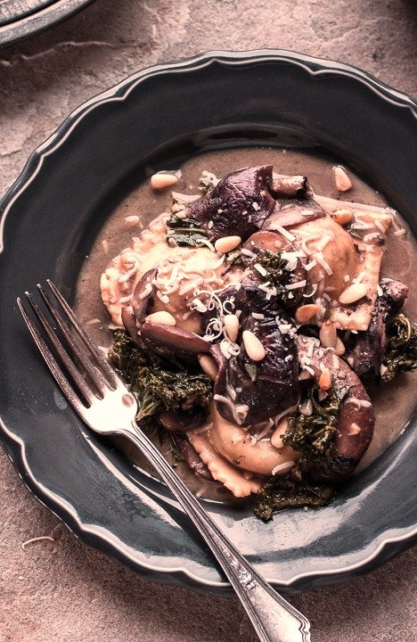 Taleggio Ravioli with Garlic-Butter Kale and Mushroom Sauce and Toasted Pine Nuts